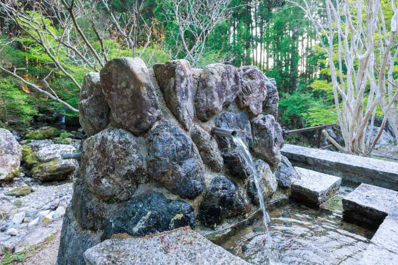 八重谷湧水の写真「駐車場の湧き水くみ場」