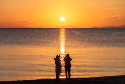 香良洲海岸の写真「朝日を眺める２人」