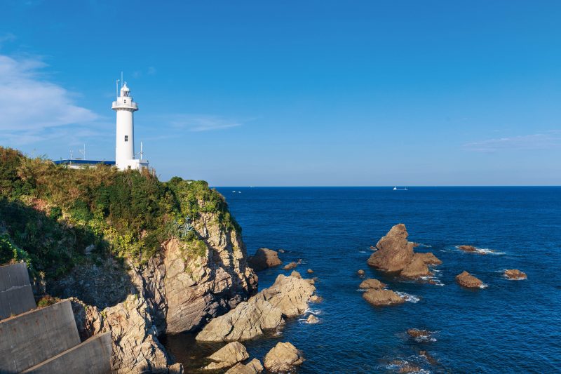 大王埼灯台の写真「白亜の灯台と波切の海」