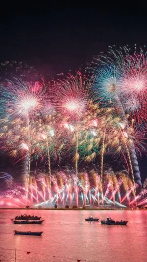 無料スマホ壁紙 ピンクに染まる夜空と揖斐川の花火。AndroidとiPhoneに対応した4K高画質の無料待ち受け画像。三重県桑名市の桑名水郷花火大会で撮影したフリー写真素材