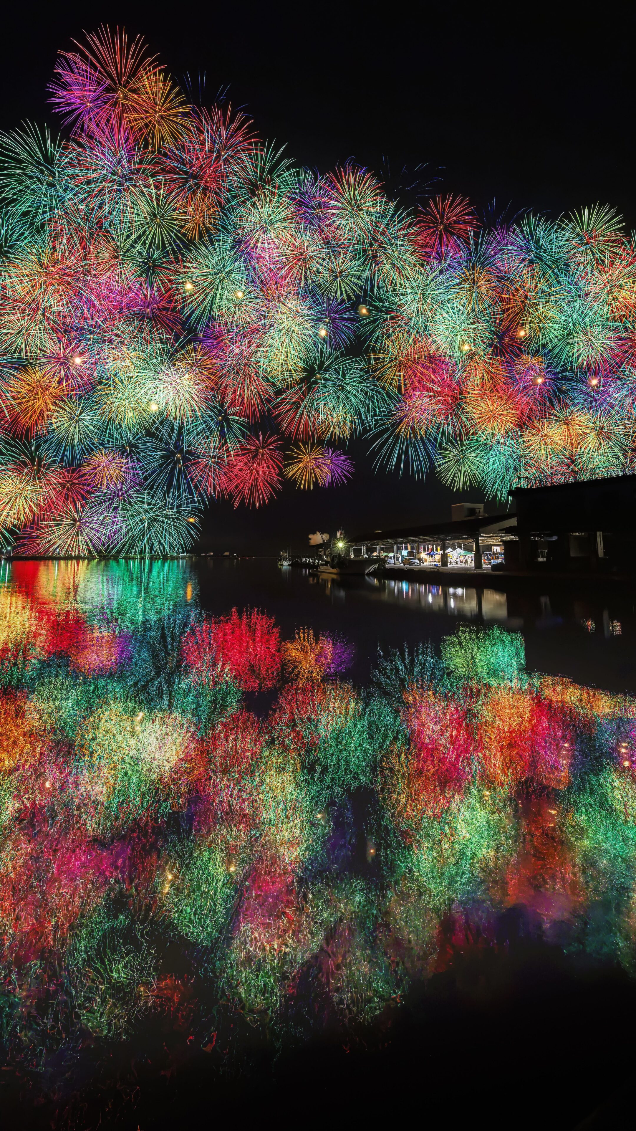 無料スマホ壁紙 アーチを描く虹色の花火。AndroidとiPhoneに対応した4K高画質の無料待ち受け画像。三重県尾鷲市のおわせ港まつりで撮影したフリー写真素材