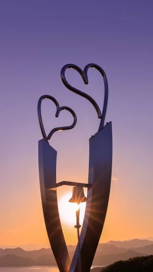 無料スマホ壁紙 幸せを呼ぶ鐘と夕陽。AndroidとiPhoneに対応した4K高画質の無料待ち受け画像。三重県南伊勢町の見江島展望台で撮影したフリー写真素材