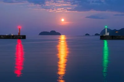 無料壁紙 まるで信号のような灯台と満月の光。PCとデスクトップ壁紙に最適な4K高画質の無料壁紙。三重県尾鷲市の尾鷲港で撮影したフリー写真素材